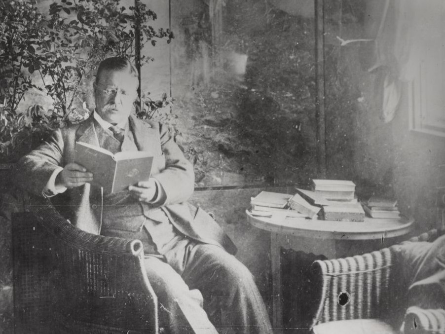 Theodore Roosevelt reading in his cabin aboard the SS Imperator, 1914