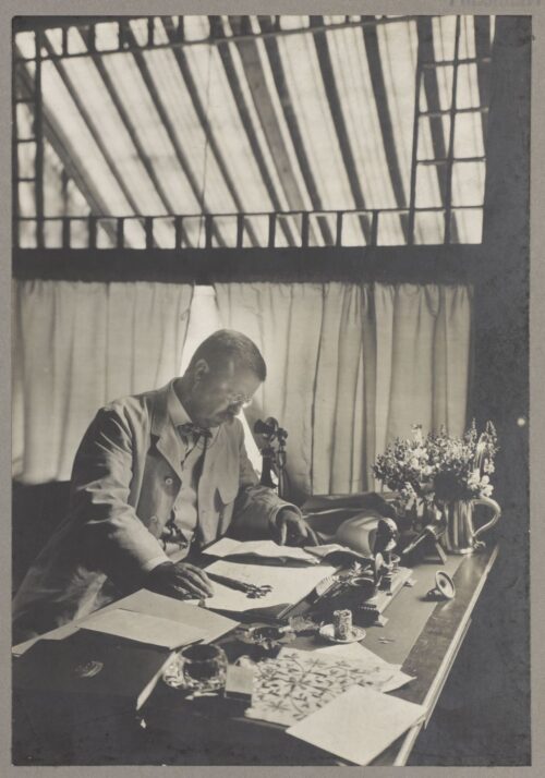 President Roosevelt sits at his desk at Sagamore Hill reviewing papers