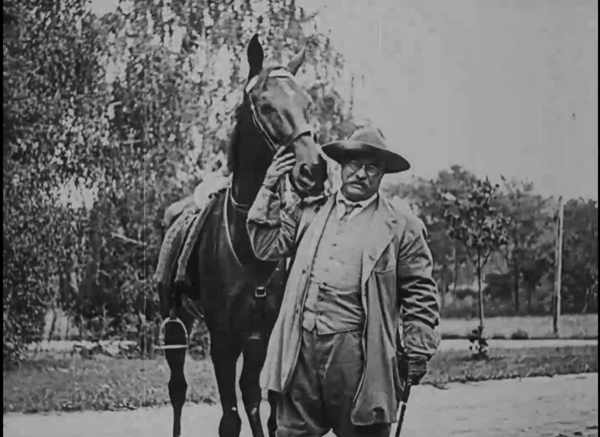 TR standing in front of a horse